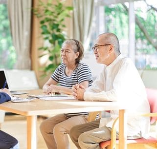 business person advising an elderly couple on buying and selling real estate